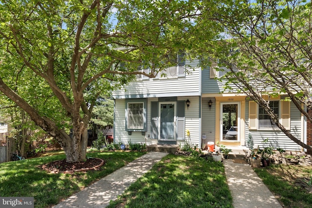 view of property featuring a front lawn