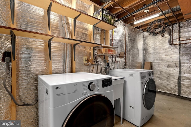clothes washing area with washer and dryer and laundry area