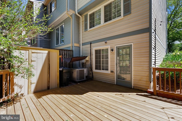 deck featuring a storage unit and cooling unit