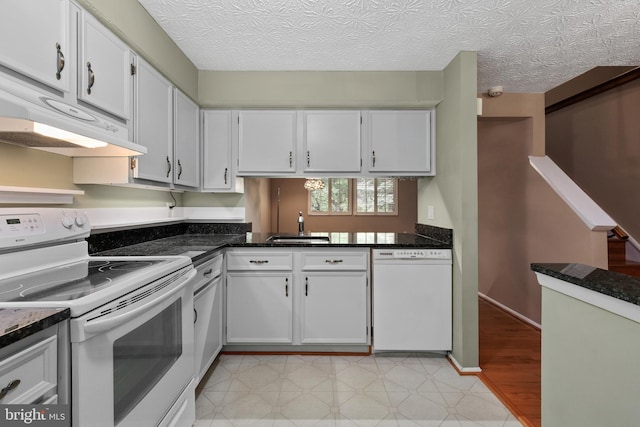 kitchen featuring light floors, white appliances, under cabinet range hood, a sink, and white cabinetry
