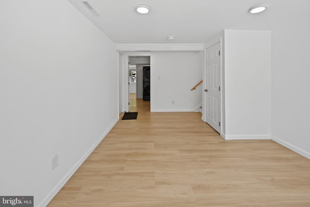 unfurnished room with stairs, baseboards, visible vents, and light wood-style floors