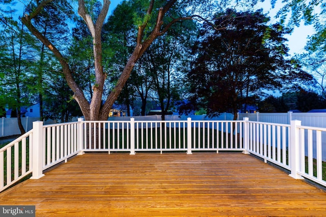 wooden terrace featuring fence