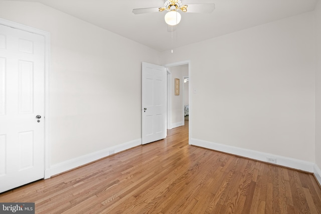 unfurnished room featuring baseboards, a ceiling fan, and light wood-style flooring