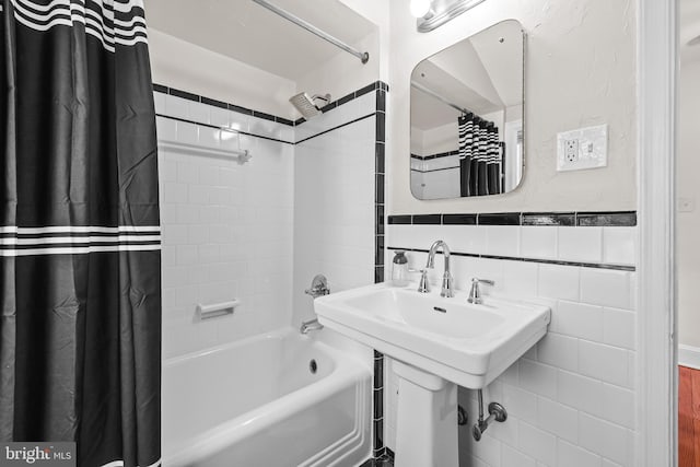 full bathroom with shower / bath combo and tile walls