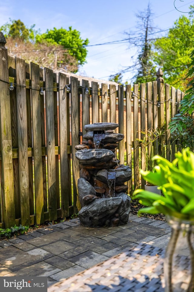 view of patio / terrace featuring fence