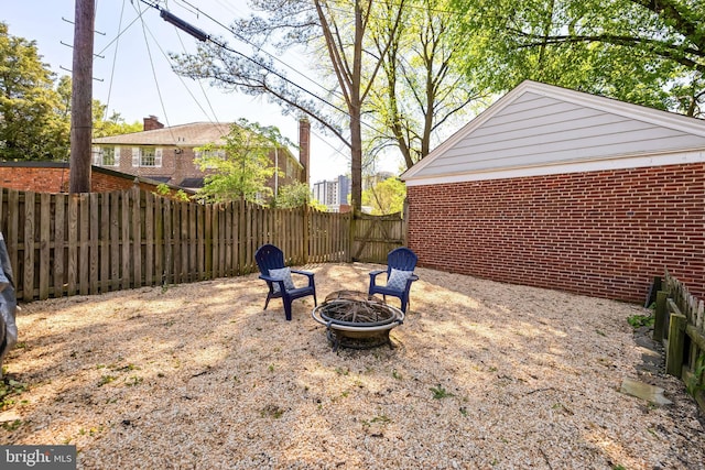 view of yard featuring fence and a fire pit