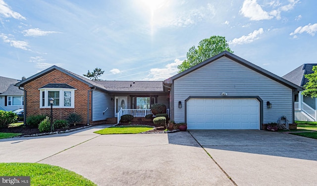 ranch-style house with concrete driveway, an attached garage, brick siding, and covered porch