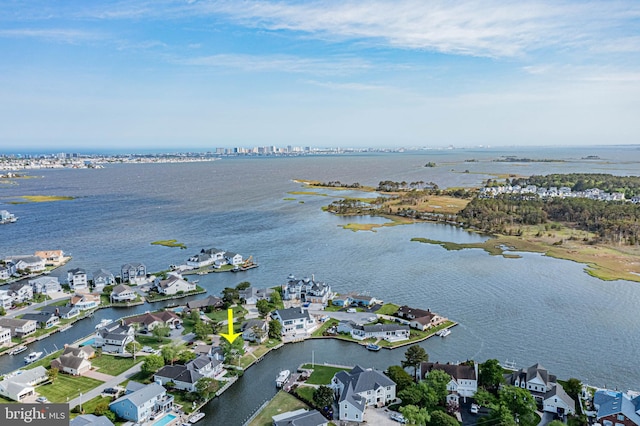 aerial view of property's location featuring a large body of water and nearby suburban area