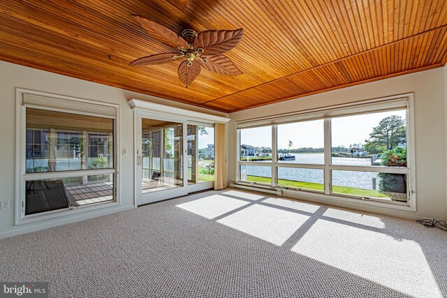 unfurnished sunroom featuring a water view