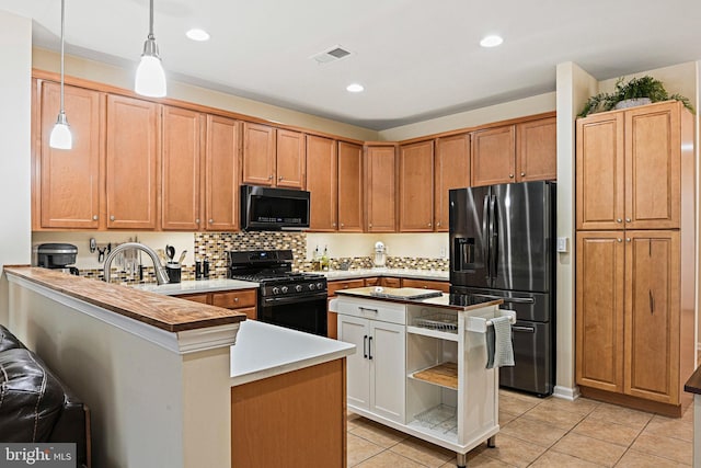 44365 Adare Manor Sq, Ashburn, VA 20147 - kitchen with black appliances, light tile patterned floors, a peninsula, pendant lighting, and recessed lighting