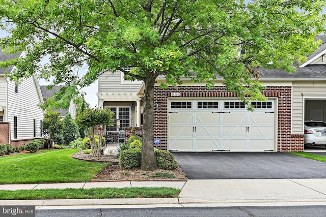 44365 Adare Manor Sq, Ashburn, VA 20147 - view of front of property featuring asphalt driveway, brick siding, a garage, and a front yard