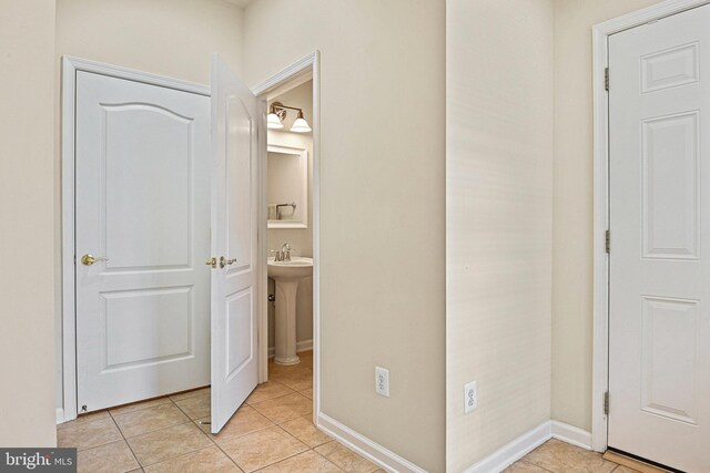 44365 Adare Manor Sq, Ashburn, VA 20147 - corridor featuring light tile patterned floors, a sink, and baseboards