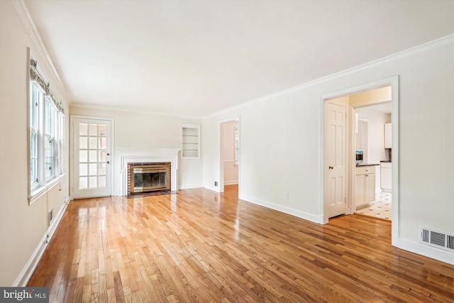 1918 Brisbane St, Silver Spring, MD 20902 - unfurnished living room featuring light wood-style flooring, built in features, ornamental molding, a fireplace with flush hearth, and baseboards