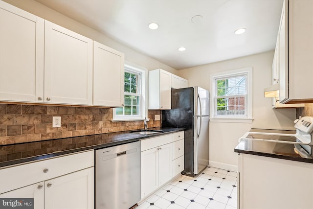 1918 Brisbane St, Silver Spring, MD 20902 - kitchen featuring stainless steel appliances, a sink, light flooring, baseboards, and dark countertops