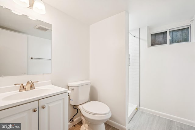 1918 Brisbane St, Silver Spring, MD 20902 - full bath featuring toilet, a shower, vanity, baseboards, and wood finished floors
