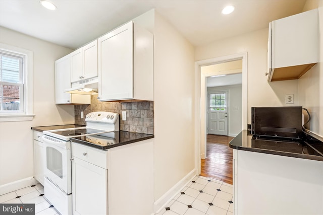 1918 Brisbane St, Silver Spring, MD 20902 - kitchen with white electric range oven, under cabinet range hood, baseboards, dark countertops, and recessed lighting