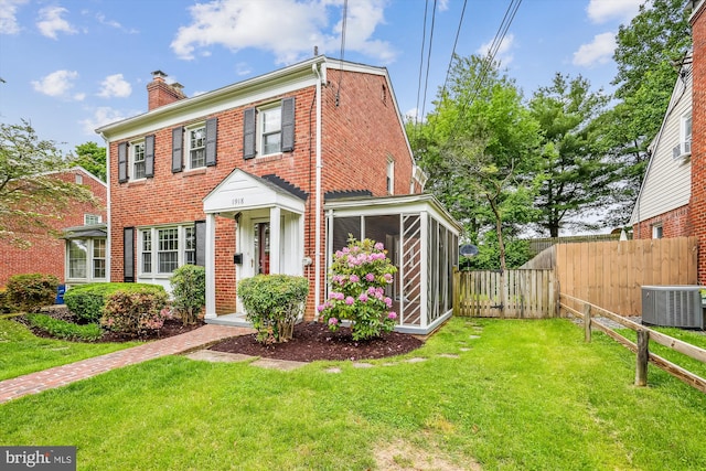 1918 Brisbane St, Silver Spring, MD 20902 - view of front of home featuring brick siding, a chimney, central AC, and a sunroom