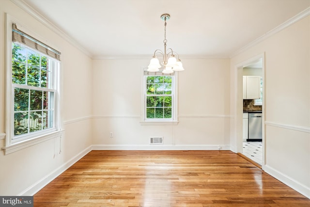 1918 Brisbane St, Silver Spring, MD 20902 - spare room with plenty of natural light, light wood-style flooring, a chandelier, baseboards, and crown molding