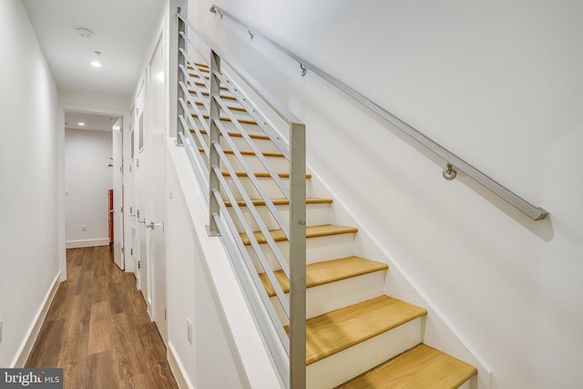 stairs with baseboards, recessed lighting, and wood finished floors