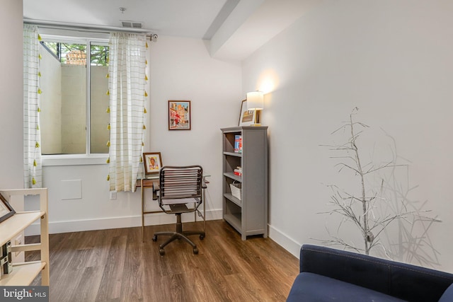 sitting room with baseboards and wood finished floors