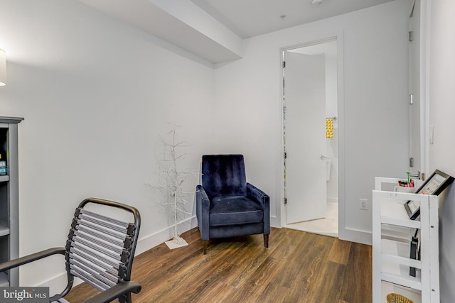 interior space featuring baseboards and wood finished floors