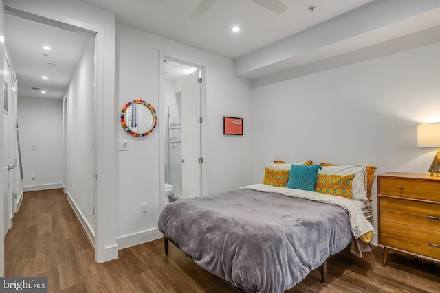 bedroom with recessed lighting, baseboards, ensuite bath, and wood finished floors