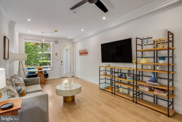 living area with crown molding, a ceiling fan, recessed lighting, and wood finished floors