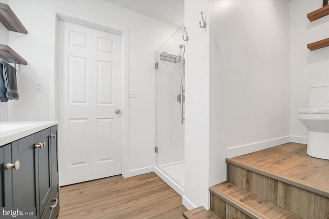 115 Penn St, Millheim, PA 16854 - full bathroom featuring vanity, a stall shower, baseboards, and wood finished floors
