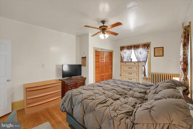 115 Penn St, Millheim, PA 16854 - bedroom featuring ceiling fan, radiator heating unit, light wood finished floors, and a closet