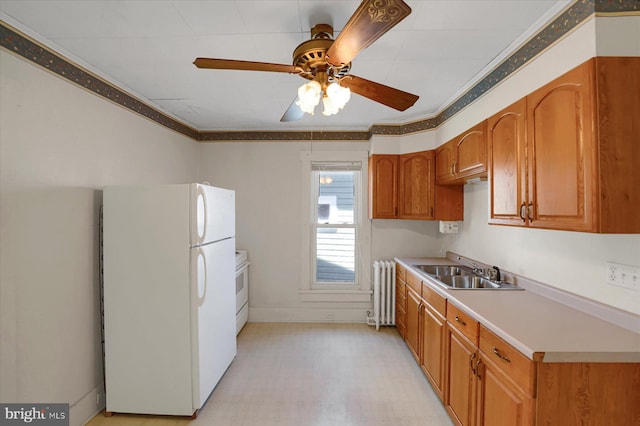 115 Penn St, Millheim, PA 16854 - kitchen with a ceiling fan, a sink, radiator heating unit, ornamental molding, and white appliances