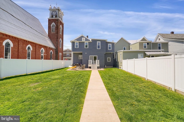 115 Penn St, Millheim, PA 16854 - rear view of house with a yard, a patio, a residential view, and a fenced backyard