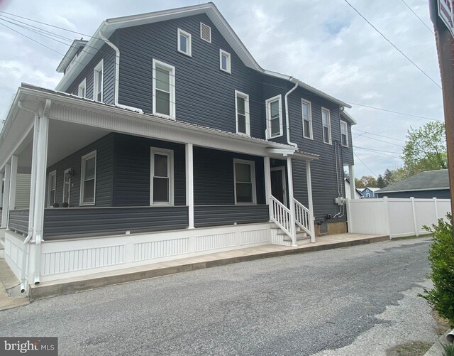 115 Penn St, Millheim, PA 16854 - farmhouse inspired home with fence and covered porch
