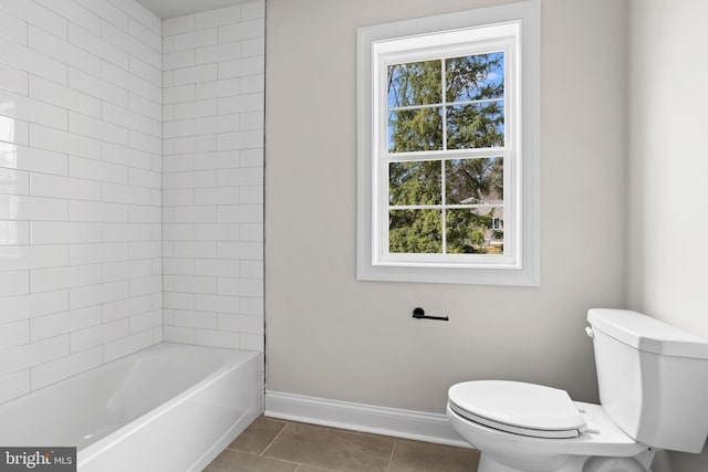 bathroom featuring tile patterned floors, baseboards, toilet, and plenty of natural light