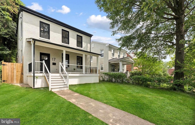 17 Longfellow St NW, Washington, DC 20011 - view of front of home with covered porch, brick siding, and a front yard