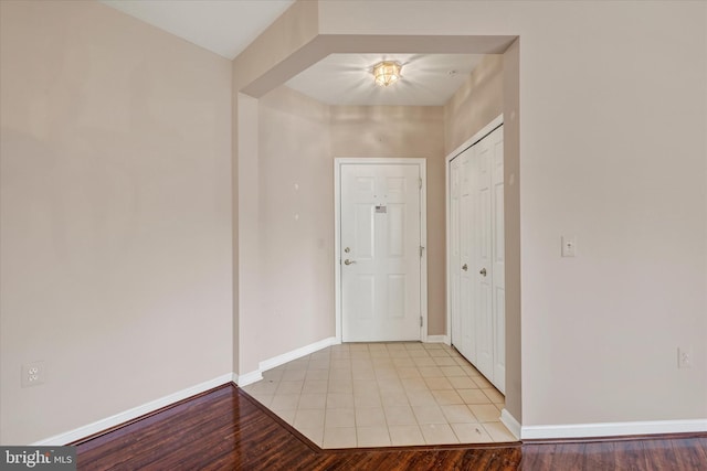 entrance foyer with baseboards and light wood-style flooring