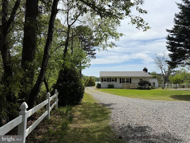 2260 Iberis Rd, Lancaster, VA 22503 - view of front of home featuring a chimney, fence, gravel driveway, and a front yard