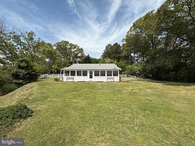 2260 Iberis Rd, Lancaster, VA 22503 - back of property featuring a sunroom, fence, a yard, and a chimney