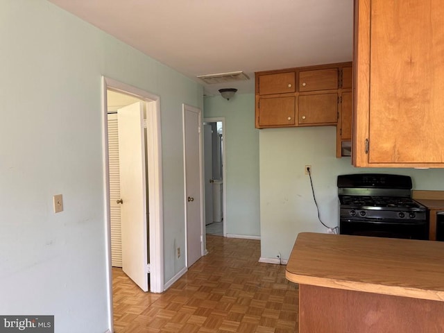 2260 Iberis Rd, Lancaster, VA 22503 - kitchen with brown cabinetry, visible vents, baseboards, light countertops, and gas stove