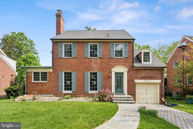 1111 Woodside Pkwy, Silver Spring, MD 20910 - colonial house featuring driveway, a chimney, a garage, brick siding, and a front lawn