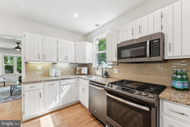 1111 Woodside Pkwy, Silver Spring, MD 20910 - kitchen with a sink, appliances with stainless steel finishes, ceiling fan, and white cabinetry