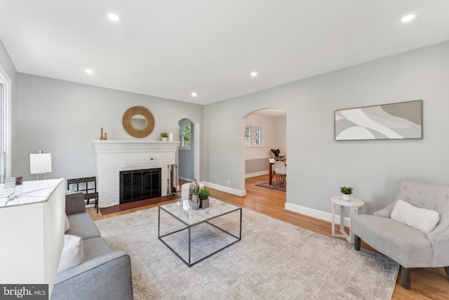 1111 Woodside Pkwy, Silver Spring, MD 20910 - living room with recessed lighting, arched walkways, and light wood finished floors