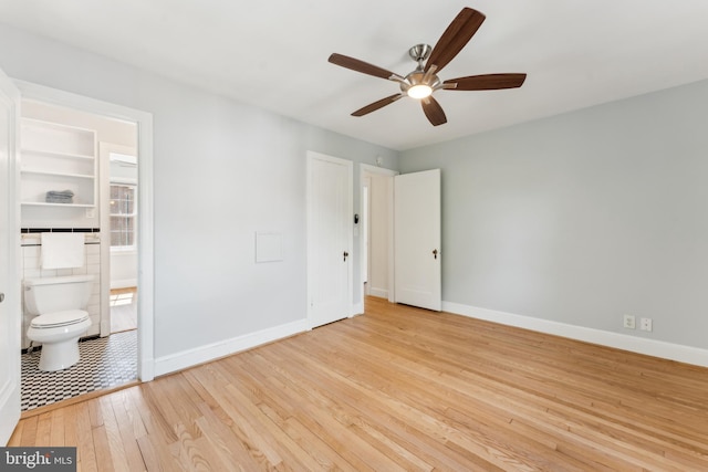 1111 Woodside Pkwy, Silver Spring, MD 20910 - unfurnished bedroom with baseboards, hardwood / wood-style flooring, and ensuite bath
