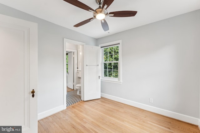 1111 Woodside Pkwy, Silver Spring, MD 20910 - unfurnished bedroom with baseboards, ensuite bathroom, wood finished floors, and ceiling fan
