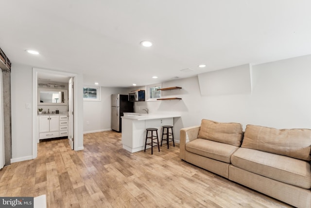 1111 Woodside Pkwy, Silver Spring, MD 20910 - living room with recessed lighting, baseboards, and light wood finished floors