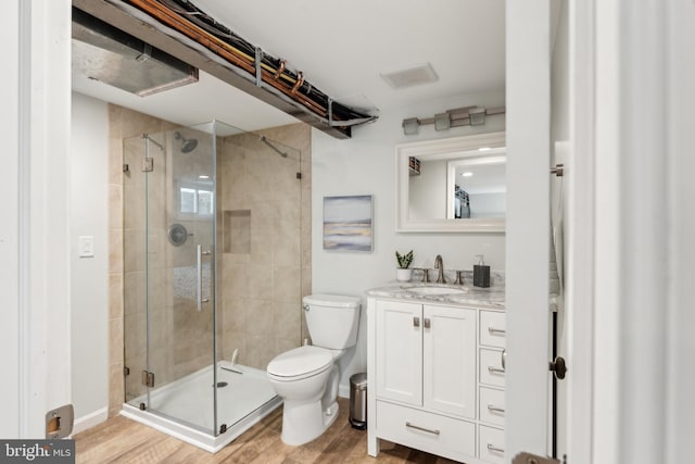 1111 Woodside Pkwy, Silver Spring, MD 20910 - bathroom featuring vanity, toilet, baseboards, a shower stall, and wood finished floors
