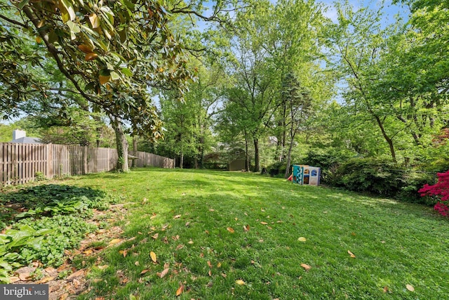 1111 Woodside Pkwy, Silver Spring, MD 20910 - view of yard with an outdoor structure, a fenced backyard, and a storage unit