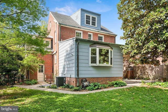 1111 Woodside Pkwy, Silver Spring, MD 20910 - view of side of property with a lawn, central AC, and fence