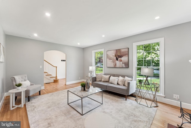 1111 Woodside Pkwy, Silver Spring, MD 20910 - living area with arched walkways, recessed lighting, wood finished floors, and stairway