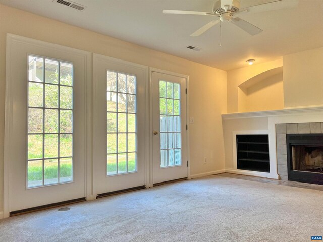 entryway with visible vents, a wealth of natural light, and carpet floors