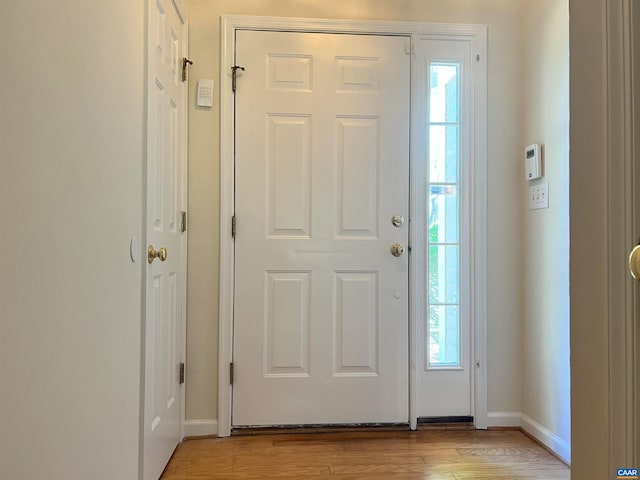 entryway featuring light wood finished floors and baseboards